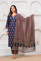 Woman wearing a navy blue cotton kurta with red floral handblock prints, matching zigzag patterned trousers, and a coordinating printed dupatta.